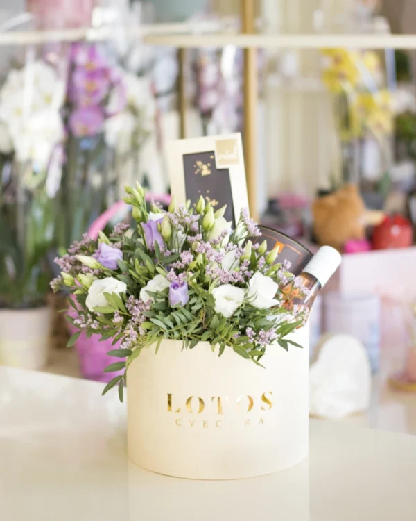 Flower box sačinjen od šarenolikog cveća, čokolada i vina